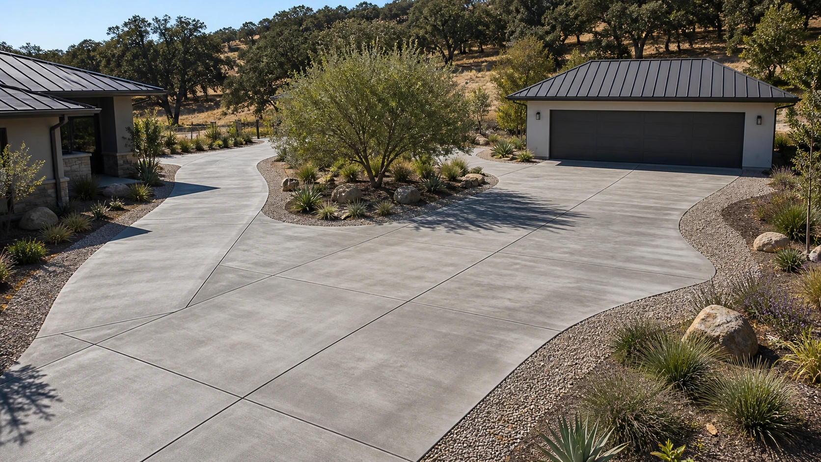 Motor court where a concrete driving surface transitions to a bordered gravel field.